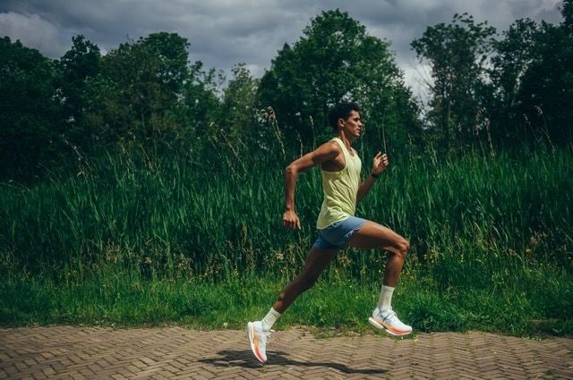 Noah running past tall grass